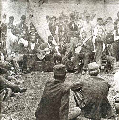 Rare photograph of Union army camp scene where soldiers are entertained by African American minstrel performers. No other information has been found about this photo